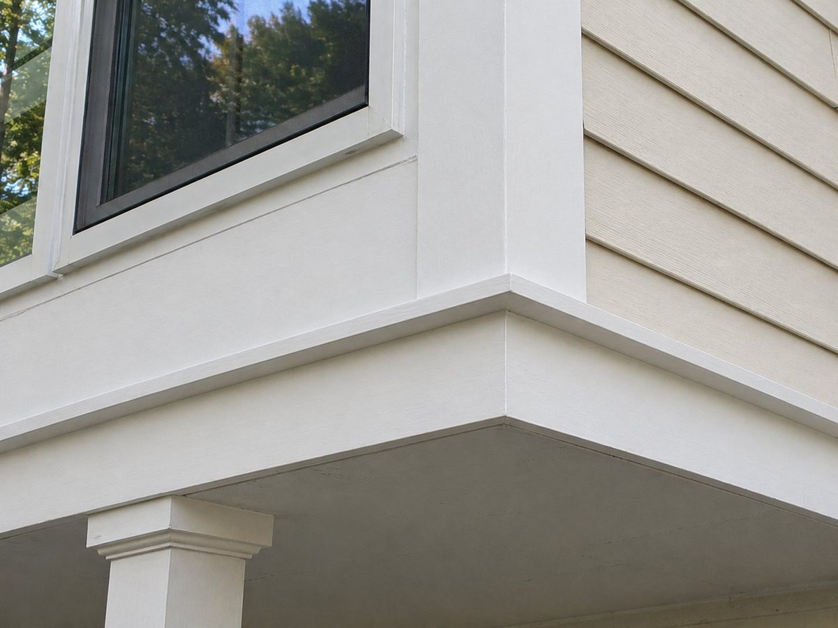 Exterior carpentry after repair — new trim and boards installed