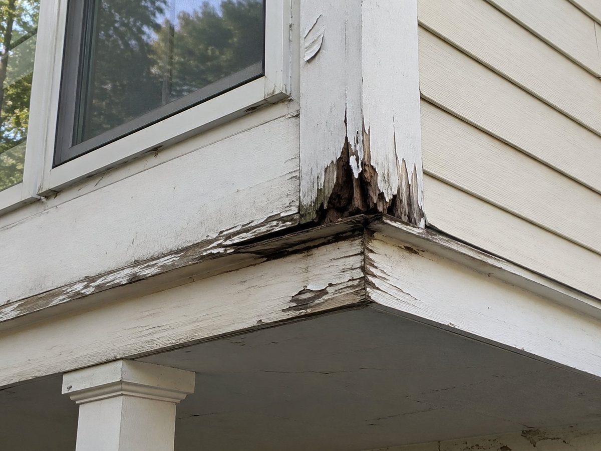 Exterior carpentry before repair — damaged and rotting wood